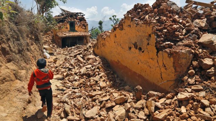 Source : Foxnews.com May 2, 2015: A Nepalese boy runs past houses destroyed by last week's earthquake in Pauwathok village, Sindhupalchok district, Nepal. (AP)